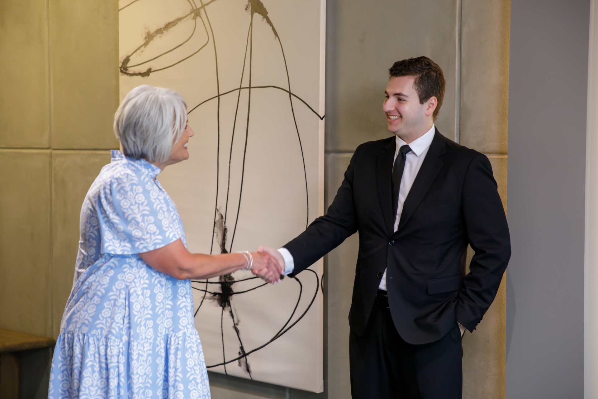 Sparks Law attorney greeting a client at the firm.