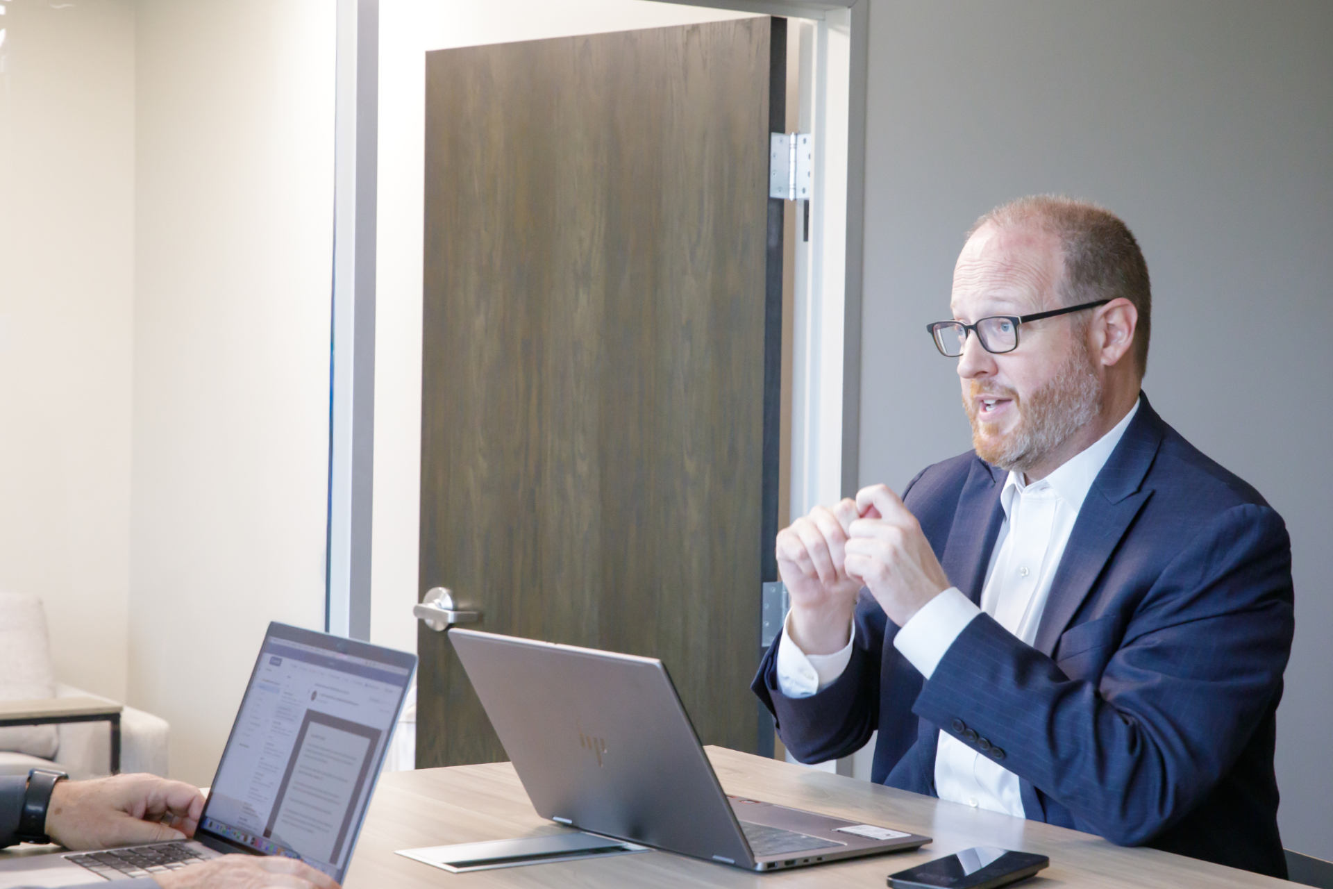 Matthew Sparks in conversation with a client at the firm.